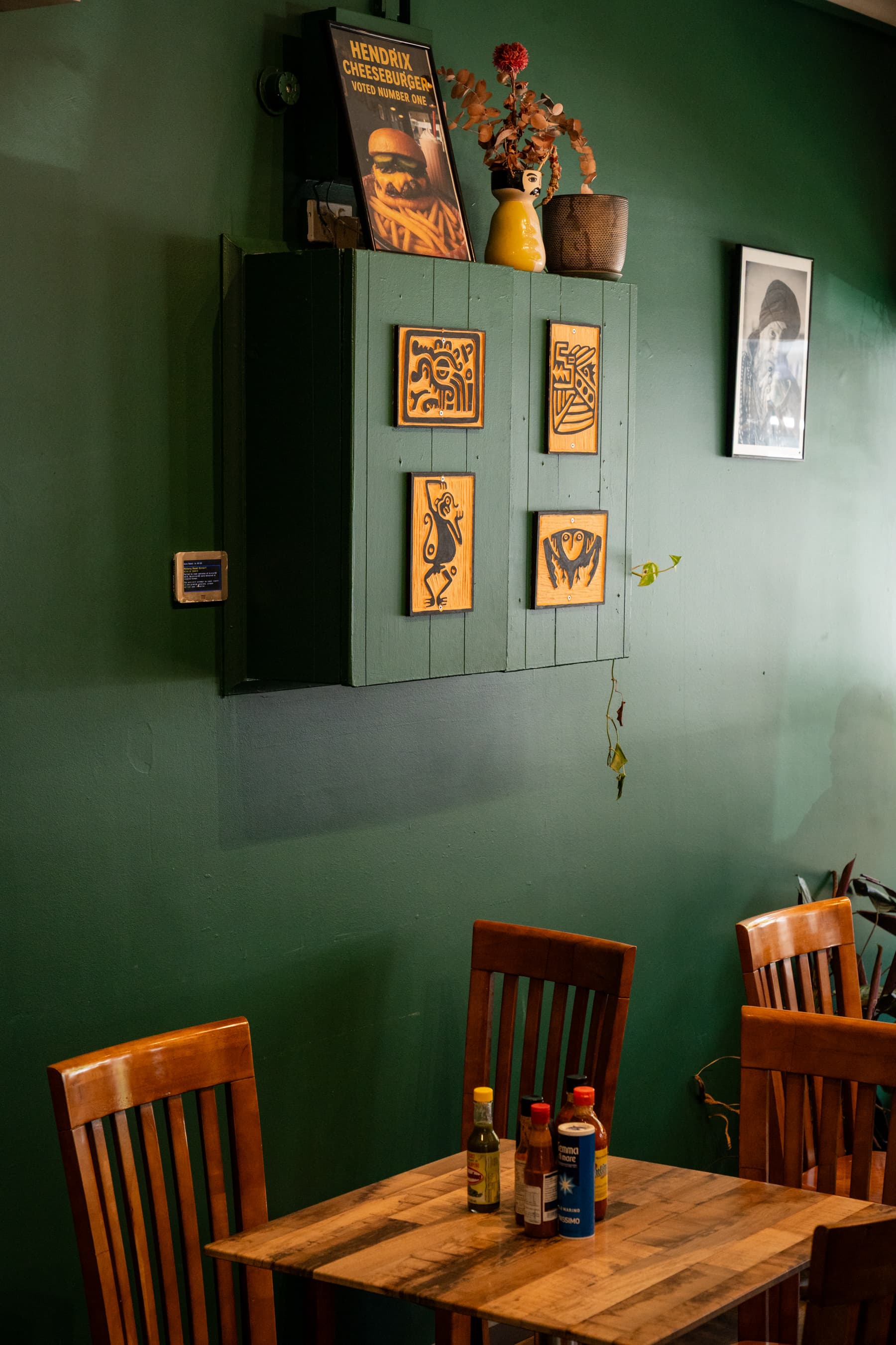 Moody cafe interior with dark walls and timber tables