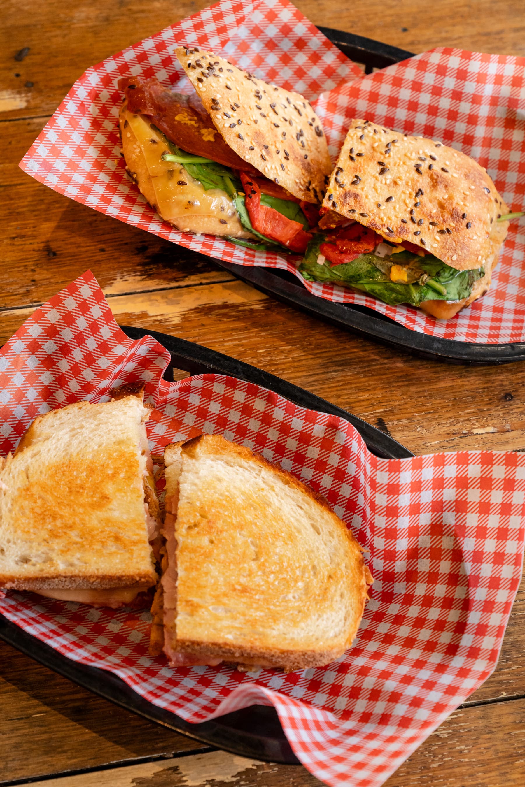 Toasted sandwiches and seeded rolls in cafe baskets