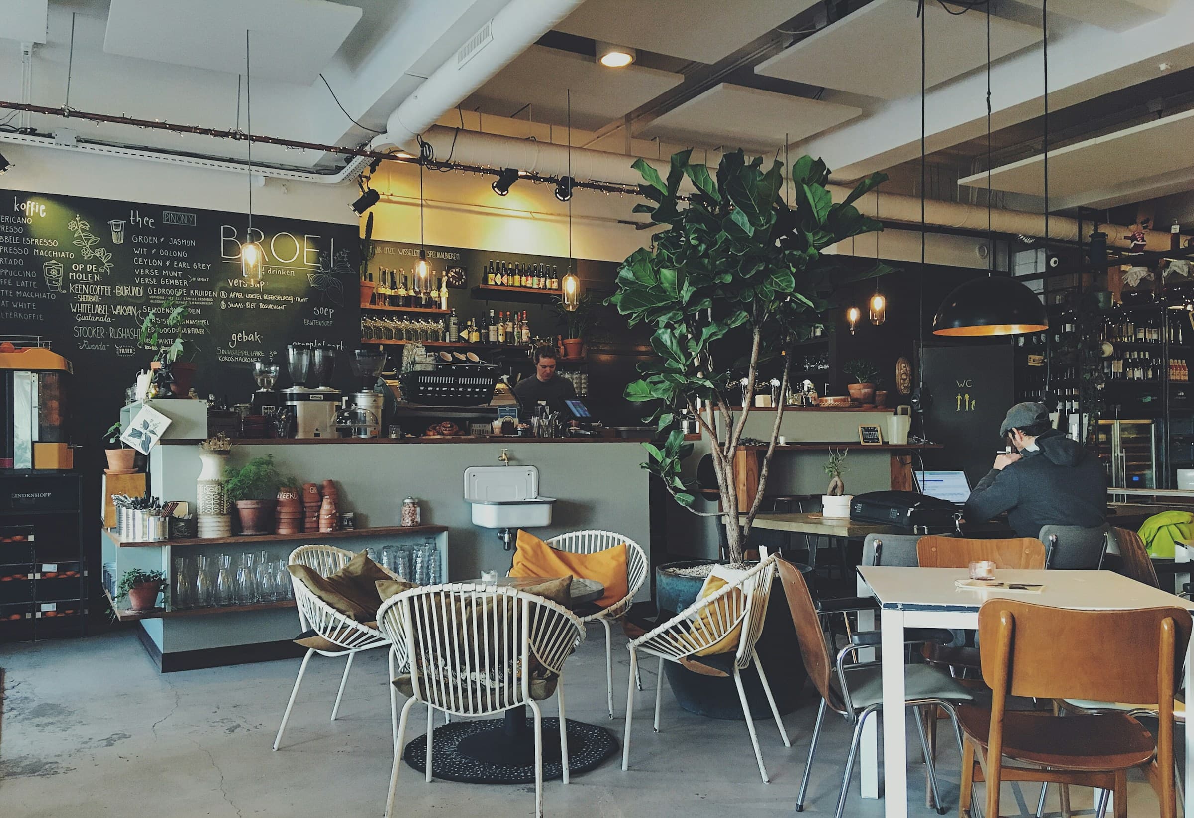 Warm moody cafe interior with coffee and timber tables